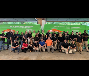 large group of people in front of a van