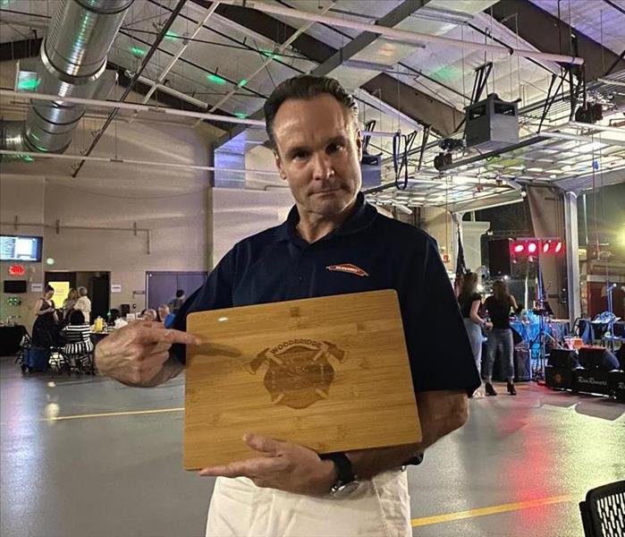 Man holding a plaque