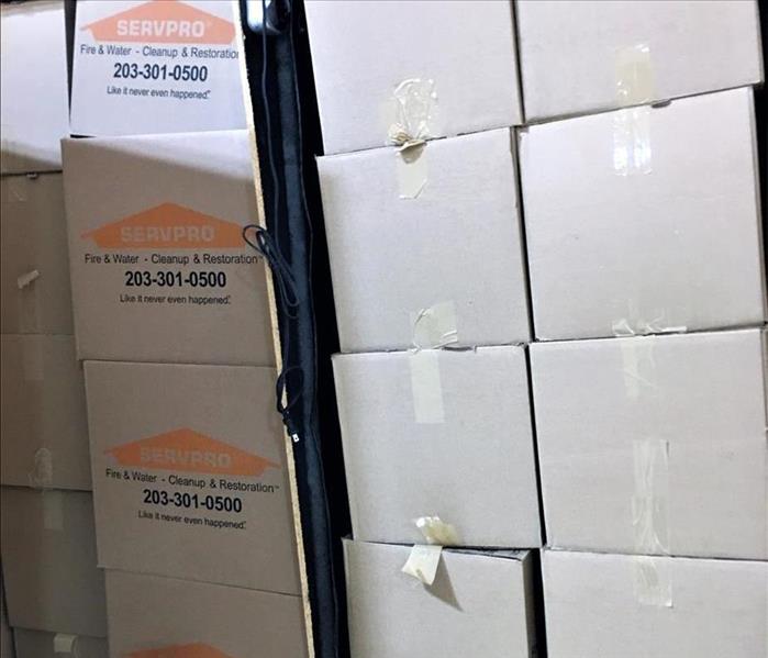 Stacks of boxes with the servpro logo on them