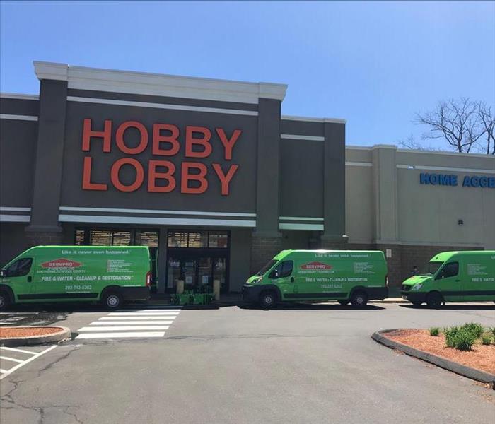 2 SERVPRO trucks in front of a hobby lobby store