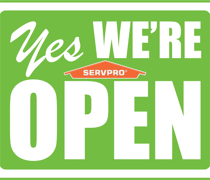 a sign that says "we're open" and the SERVPRO logo