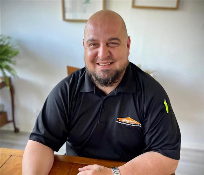 Man Smiling sitting at a desk