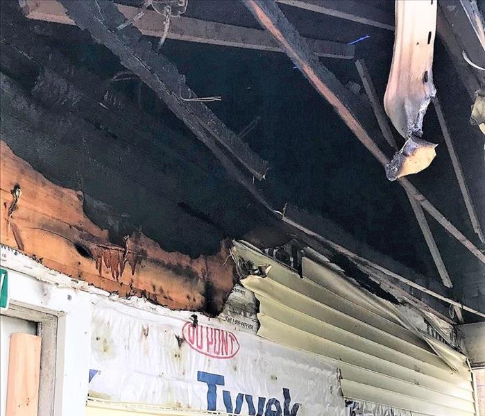 exterior of a house with burned siding and wood