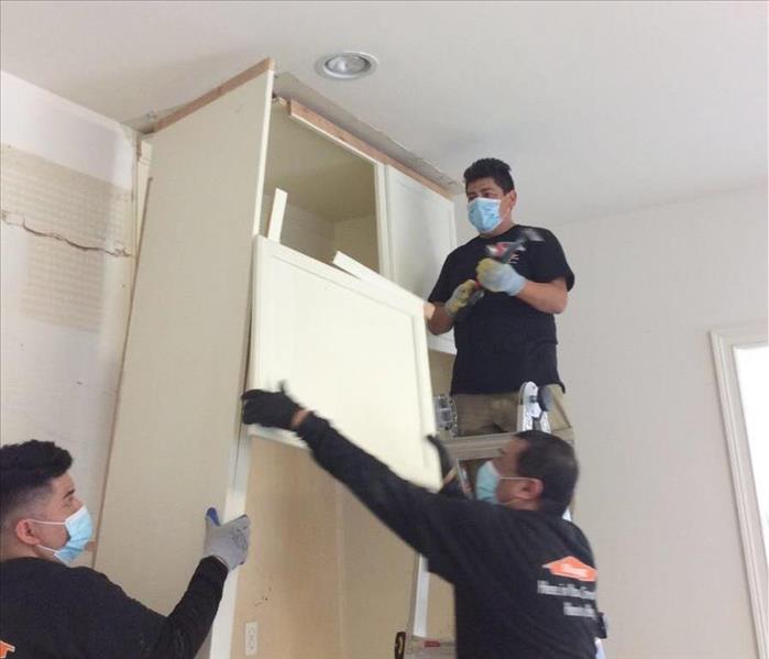 Men removing drywall 